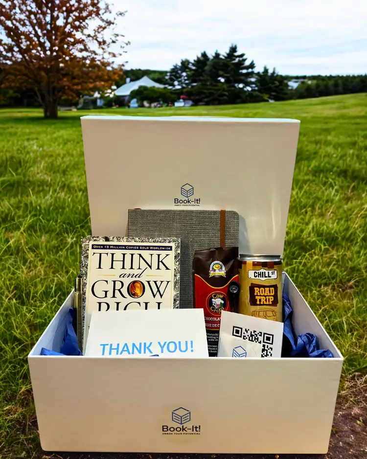A Book-It! subscription box with a copy of the book "Think and Grow Rich" and various self-care items inside.