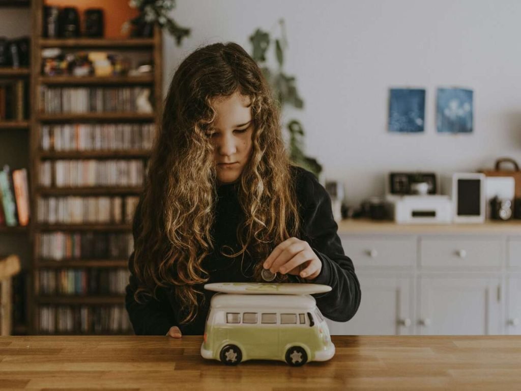Young person saving money in piggy bank for TFSA investment